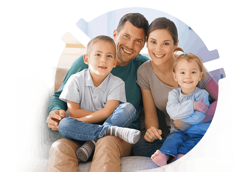 Happy family of four sitting closely together on a couch