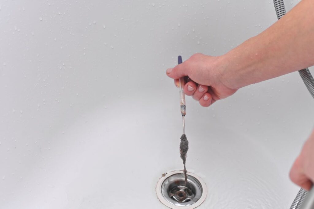 Slow draining tub removing hair from drain
